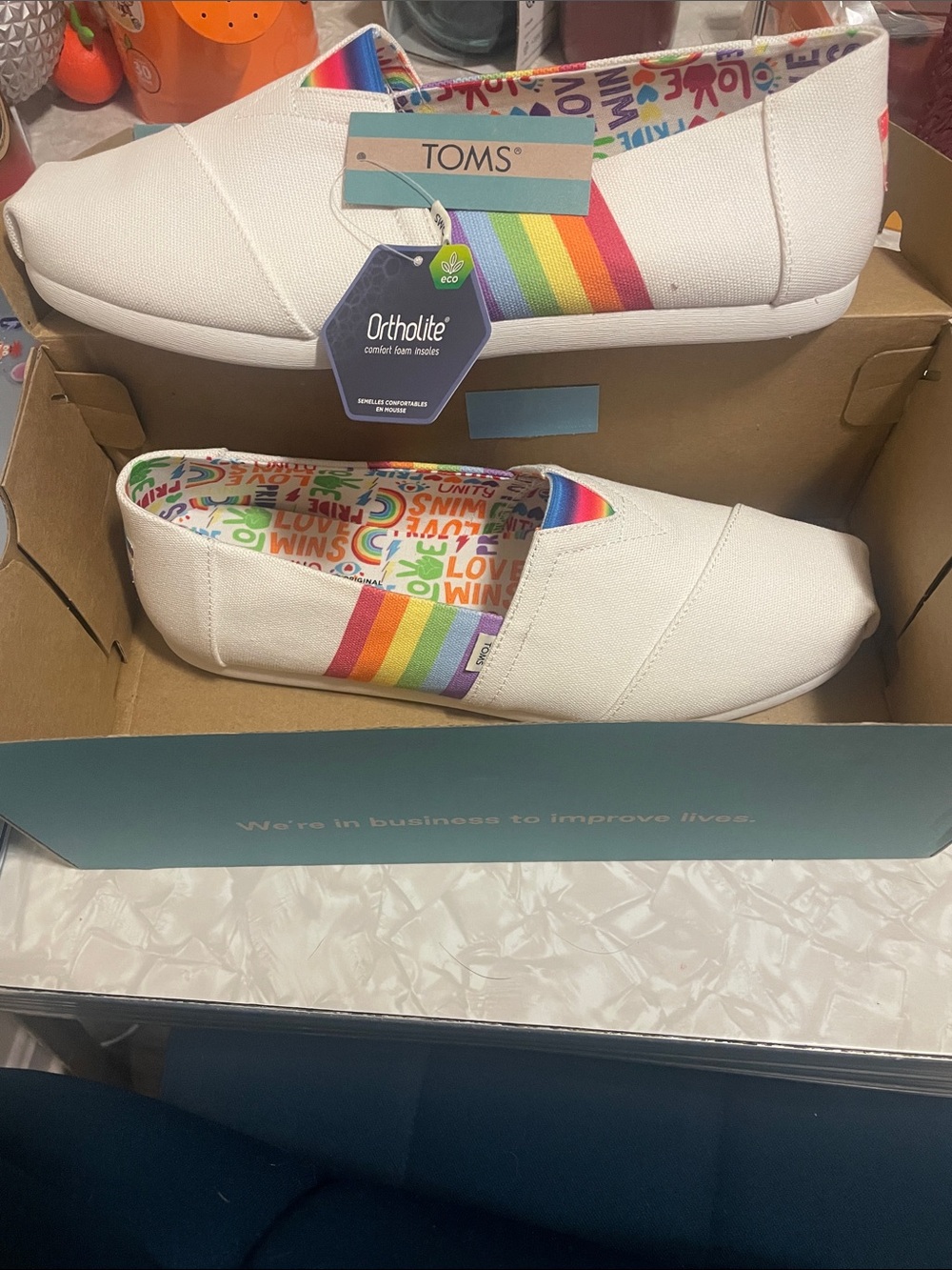 TOMS White Canvas Slip-Ons with Rainbow Stripes